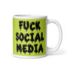 White and lime green ceramic coffee mug with the text 'Fuck social media' printed on the front in drippy graffiti style font on both sides of the mug.