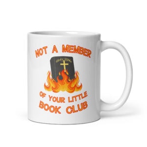 White ceramic mug with image of a burning bible and the text 'Not a member of your little book club' printed on both sides.
