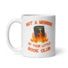 White ceramic mug with image of a burning bible and the text 'Not a member of your little book club' printed on both sides.