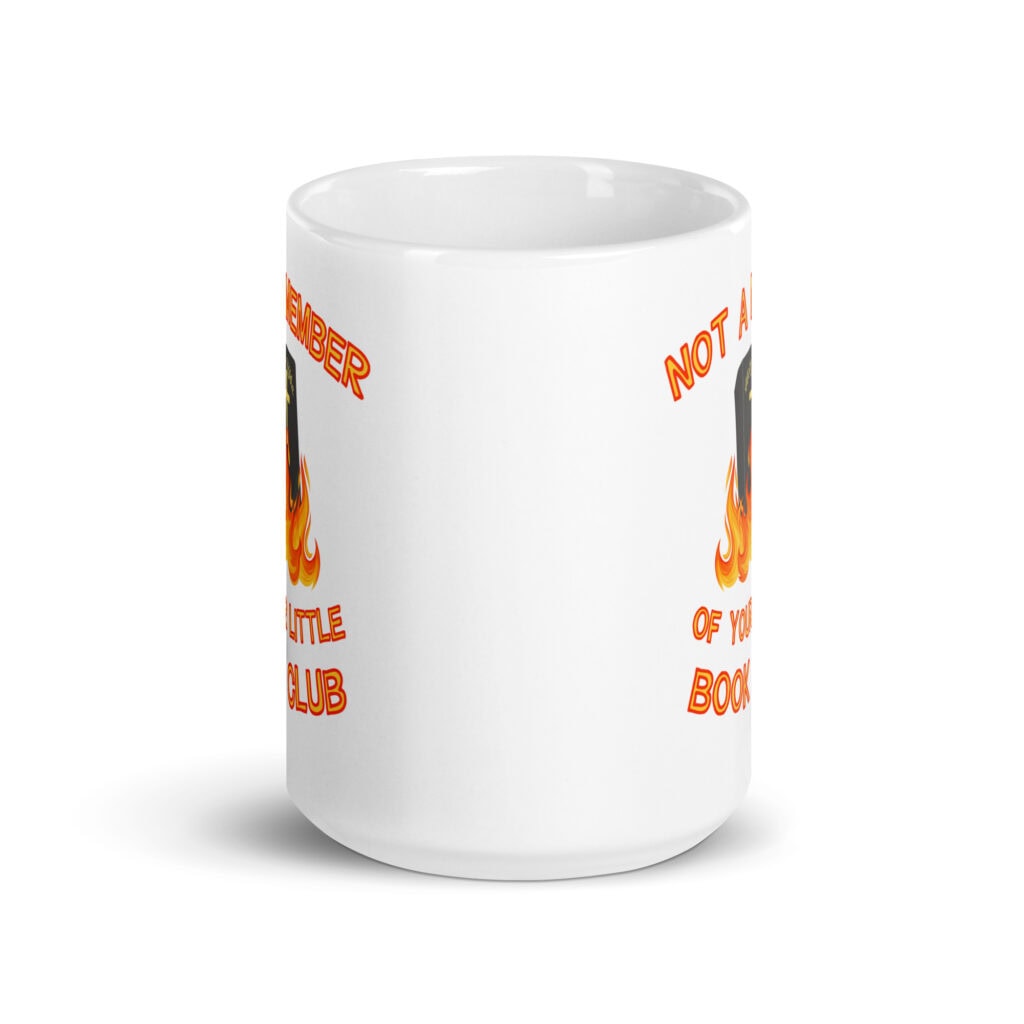 White ceramic mug with image of a burning bible and the text 'Not a member of your little book club' printed on both sides.