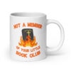 White ceramic mug with image of a burning bible and the text 'Not a member of your little book club' printed on both sides.