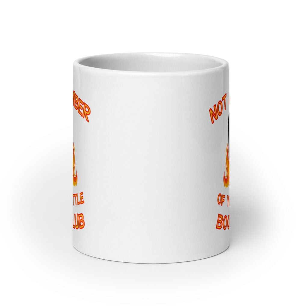 White ceramic mug with image of a burning bible and the text 'Not a member of your little book club' printed on both sides.