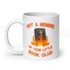 White ceramic mug with image of a burning bible and the text 'Not a member of your little book club' printed on both sides.