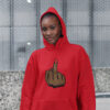 Smiling woman wearing a red hoodie sweatshirt with the hood on. The hoodie has a graphic of a brown hand showing the middle finger with the nail painted red printed on the front.