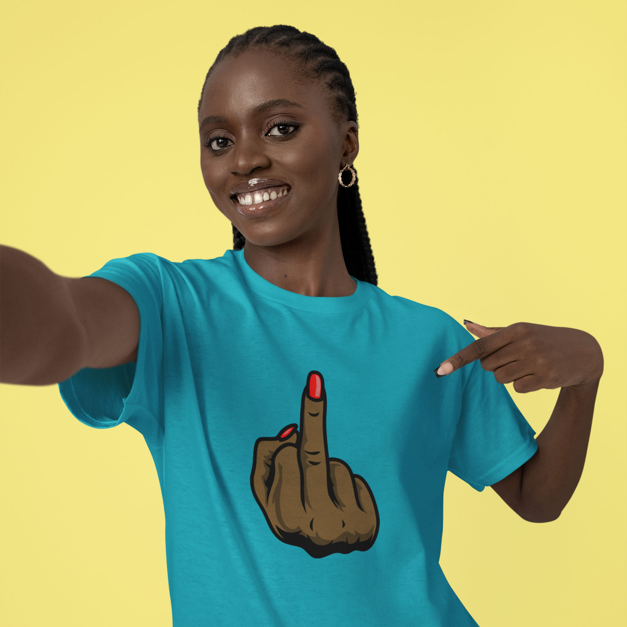 Smiling woman wearing a bright turquoise T‑shirt with a graphic of a brown hand showing the middle finger, red nail polish, against a yellow background.