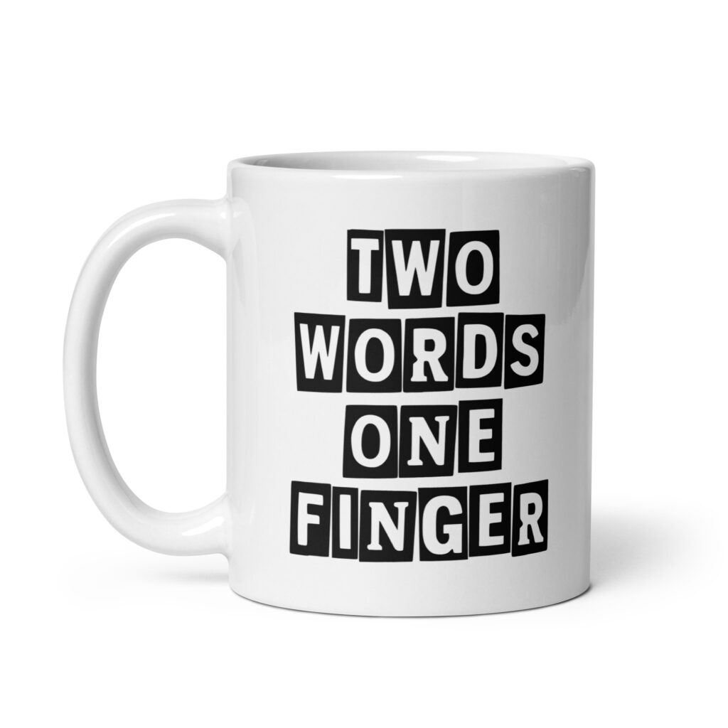 White ceramic mug with the text 'TWO WORDS ONE FINGER' printed in stencil font on both sides of the mug.