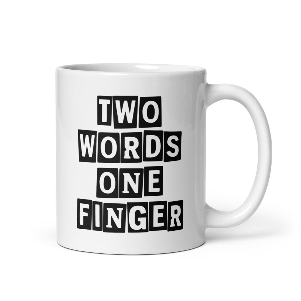 White ceramic mug with the text 'TWO WORDS ONE FINGER' printed in stencil font on both sides of the mug.