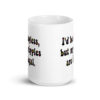 White ceramic mug with text 'I'd be topless, but my nipples are illegal.' printed on both sides in a floral font.