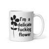 White ceramic mug with image of a flower and the text 'I'm a delicate fucking flower' printed on both sides.