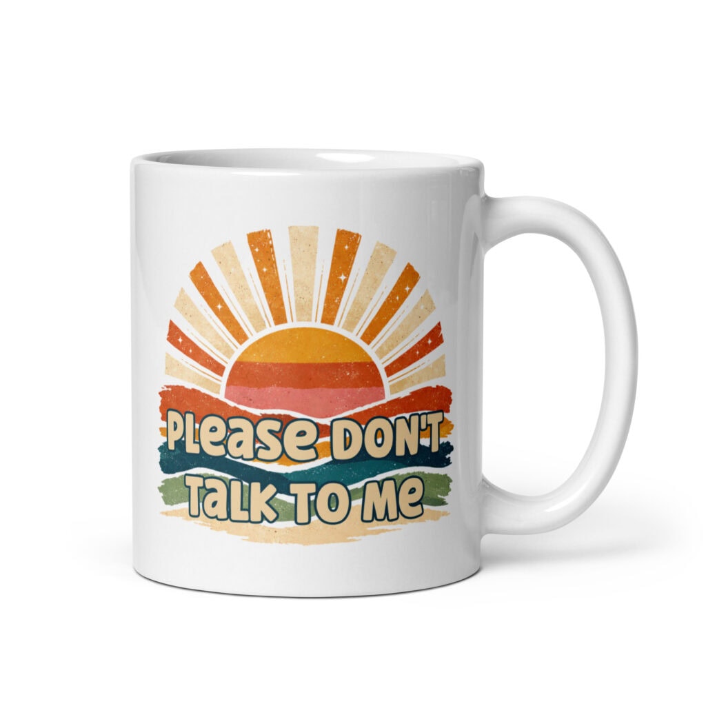 White ceramic mug with a retro sunrise design and the text 'Please don't talk to me' printed on both sides.