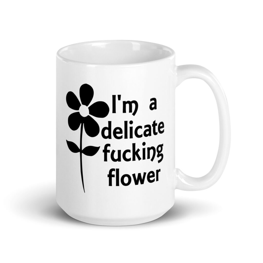 White ceramic mug with image of a flower and the text 'I'm a delicate fucking flower' printed on both sides.