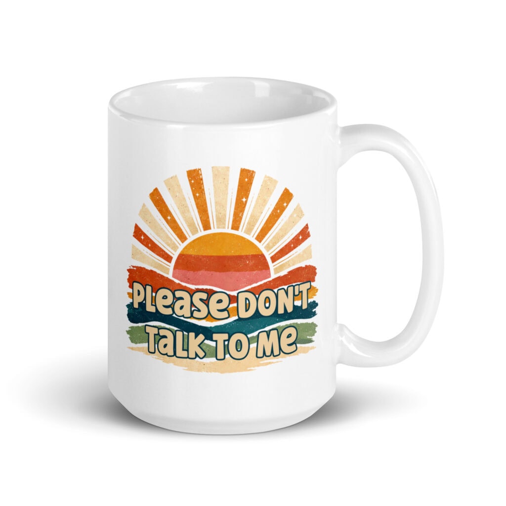 White ceramic mug with a retro sunrise design and the text 'Please don't talk to me' printed on both sides.