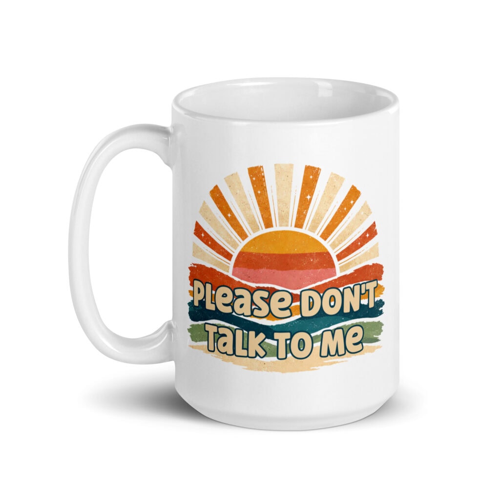 White ceramic mug with a retro sunrise design and the text 'Please don't talk to me' printed on both sides.