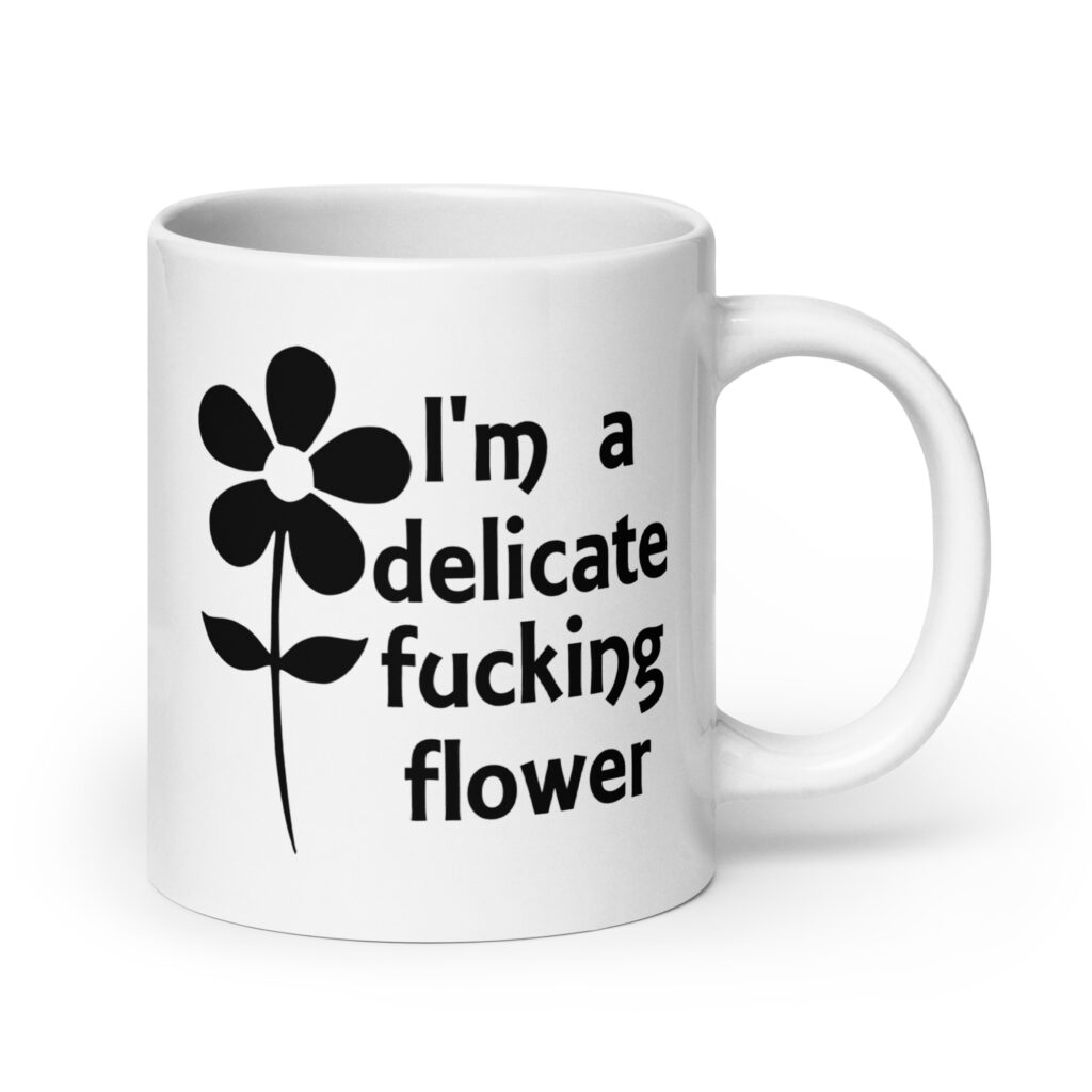 White ceramic mug with image of a flower and the text 'I'm a delicate fucking flower' printed on both sides.