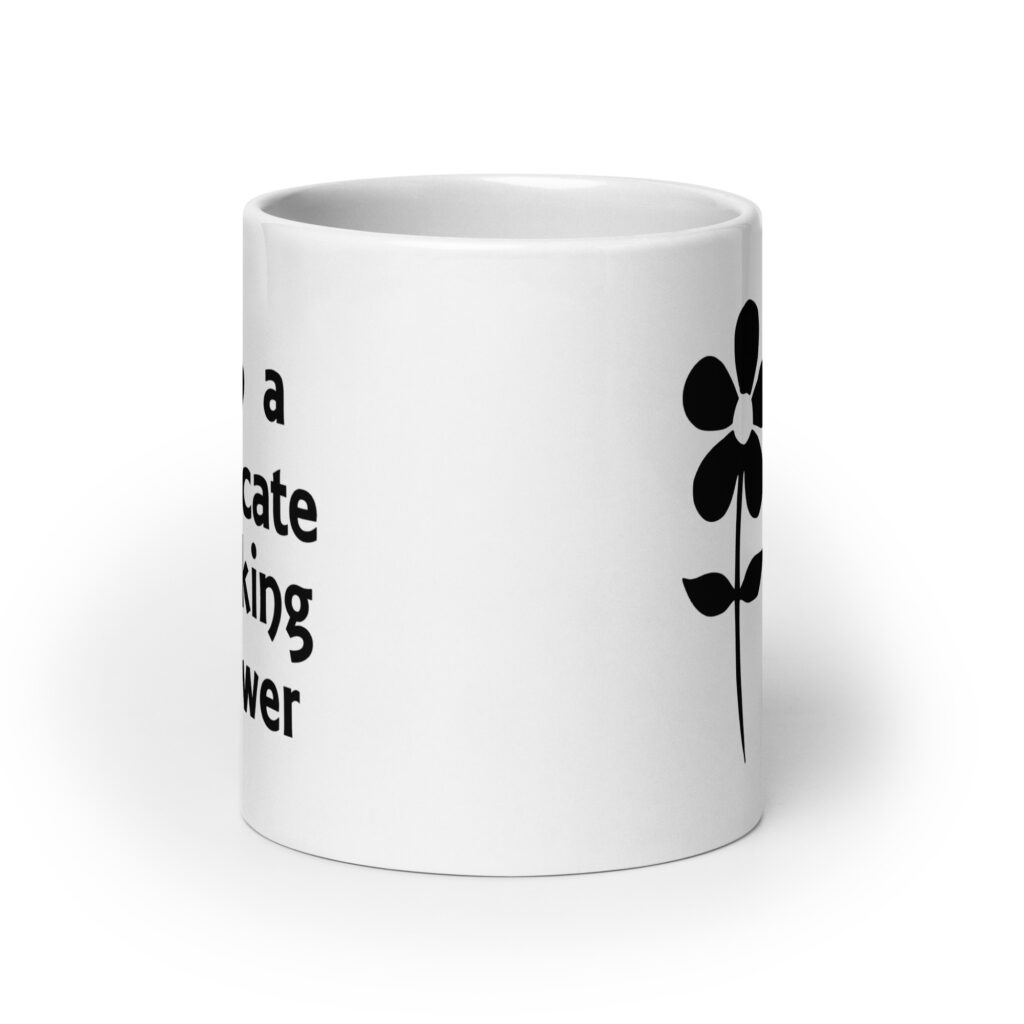 White ceramic mug with image of a flower and the text 'I'm a delicate fucking flower' printed on both sides.