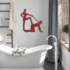 Modern bathroom with freestanding tub and minimalist red steel wall art mounted above.