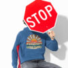 Man holding a stop sign while wearing an indigo blue hoodie sweatshirt with a retro sunrise design and the text 'Please don't talk to me' printed on the front.