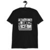 Black t-shirt with bold white text reading ‘Adulting is a Scam’ in mixed block and distressed fonts. The design includes a smiley face, star, and flower icons, with a checkerboard stripe along the bottom.