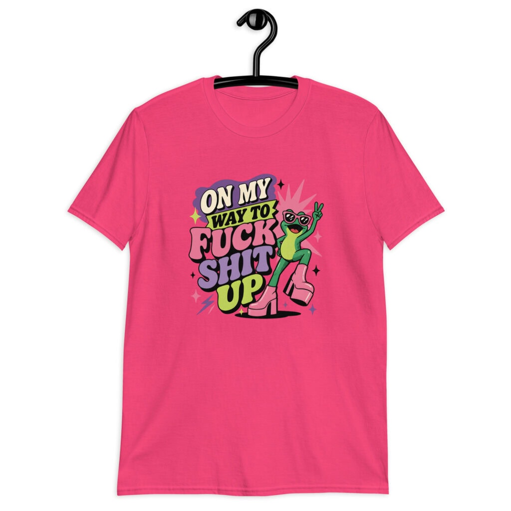 Pink t-shirt with a retro frog and the phrase “On My Way to Fuck Shit Up” printed on the front.