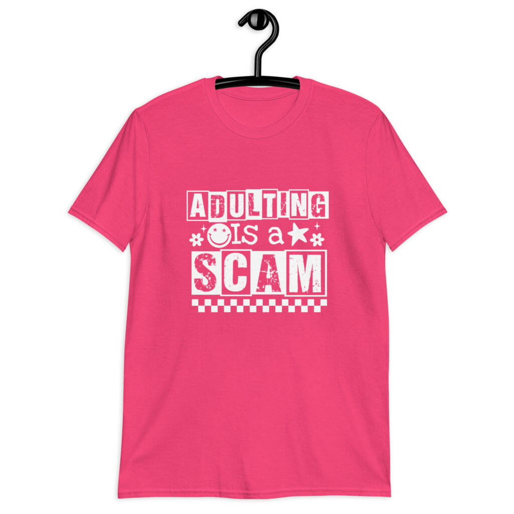 Heliconia pink t-shirt with bold white text reading ‘Adulting is a Scam’ in mixed block and distressed fonts. The design includes a smiley face, star, and flower icons, with a checkerboard stripe along the bottom.