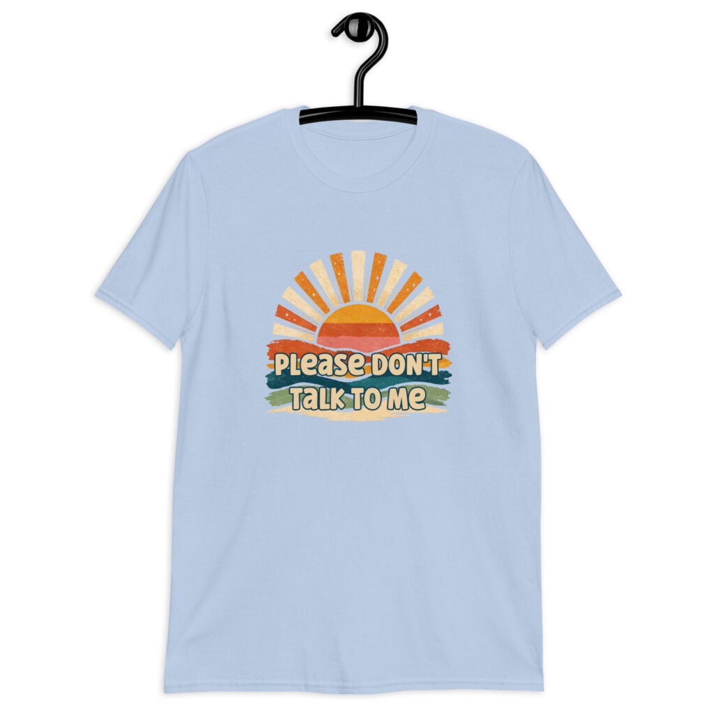 Light blue t-shirt with a retro sunrise design and the text 'Please don't talk to me' printed on the front.