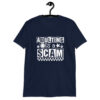 Navy blue t-shirt with bold white text reading ‘Adulting is a Scam’ in mixed block and distressed fonts. The design includes a smiley face, star, and flower icons, with a checkerboard stripe along the bottom.