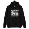 Black hoodie sweatshirt with bold white text reading ‘Adulting is a Scam’ in mixed block and distressed fonts. The design includes a smiley face, star, and flower icons, with a checkerboard stripe along the bottom.