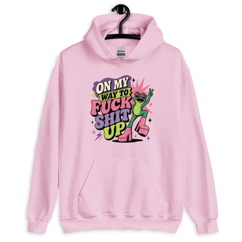 Pink hoodie with a retro frog and the phrase “On My Way to Fuck Shit Up” printed on the front.