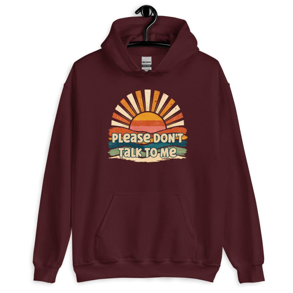 Maroon hoodie sweatshirt with a retro sunrise design and the text 'Please don't talk to me' printed on the front.