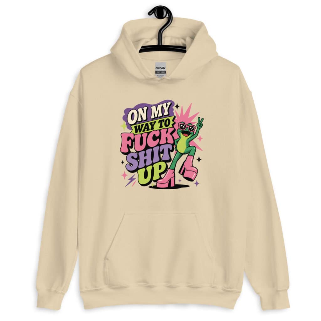 Sand color hoodie with a retro frog and the phrase “On My Way to Fuck Shit Up” printed on the front.