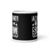 White ceramic mug featuring a black wraparound design with bold distressed white text reading ‘Adulting is a Scam.’ The text includes a smiley face, star, and flower icons, with a white checkerboard stripe along the bottom.
