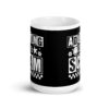 White ceramic mug featuring a black wraparound design with bold distressed white text reading ‘Adulting is a Scam.’ The text includes a smiley face, star, and flower icons, with a white checkerboard stripe along the bottom.