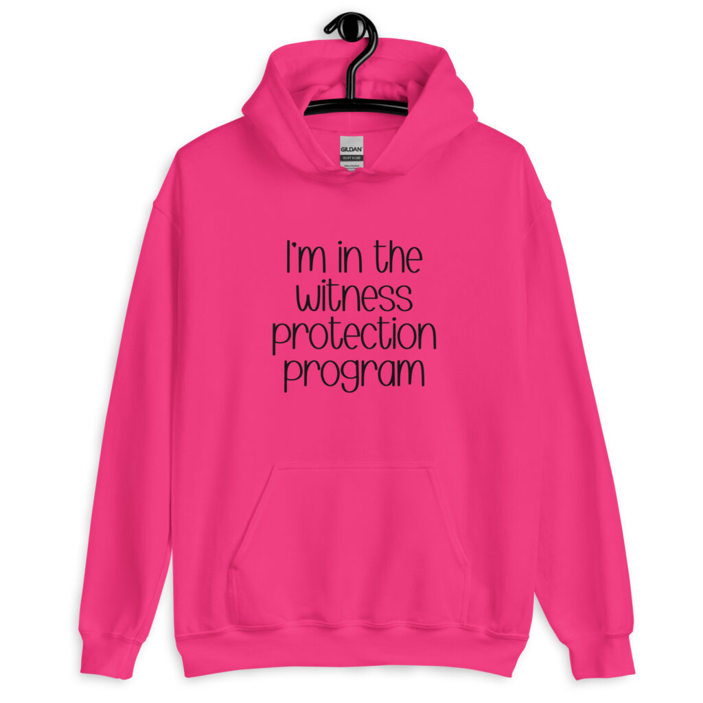 Heliconia pink hoodie sweatshirt with the text 'I'm in the witness protection program' printed on the front.