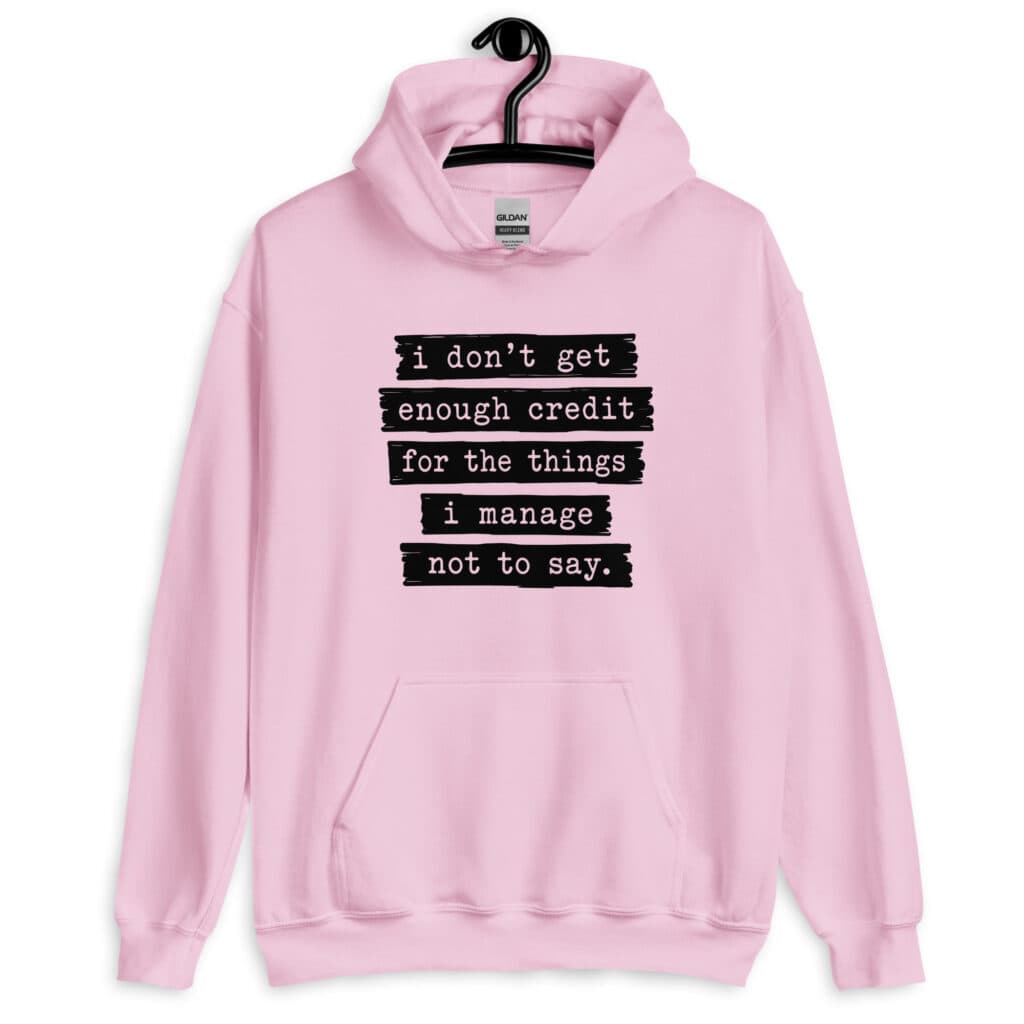 Light pink hoodie sweatshirt with the text 'I don't get enough credit for the things I manage not to say' printed on the front.
