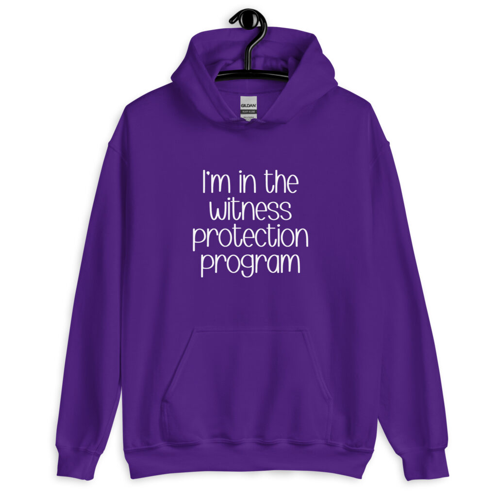 Purple hoodie sweatshirt with the text 'I'm in the witness protection program' printed on the front.