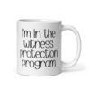 White ceramic mug with the text 'I'm in the witness protection program' printed on both sides.
