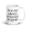 White ceramic mug with the text 'I'm in the witness protection program' printed on both sides.